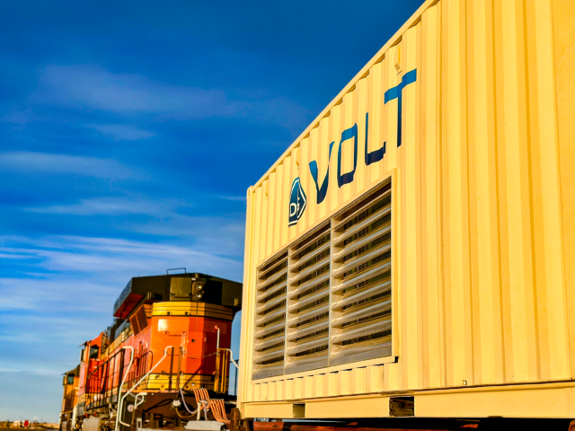 Close-up of VOLT battery unit with locomotive during rail testing operations